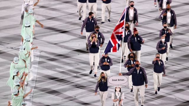 Flag bearers Hannah Mills and Mohamed Sbihi of Team Great Britain lead their team out during the Opening Ceremony of the Tokyo 2020 Olympic Games at Olympic Stadium on July 23, 2021 in Tokyo, Japan.