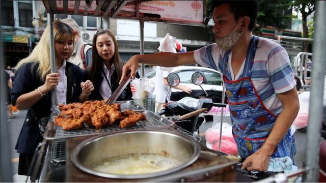 A vendor who sells fried chicken.