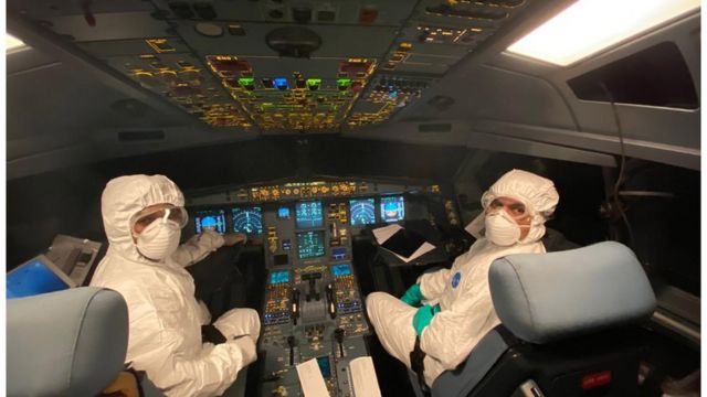 the crew members of a SriLankan Airlines Airbus A330 wearing full protective suits and masks during a humanitarian operation to evacuate Sri Lankans from Wuhan