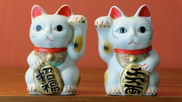 Two maneki-neko 'lucky cats'