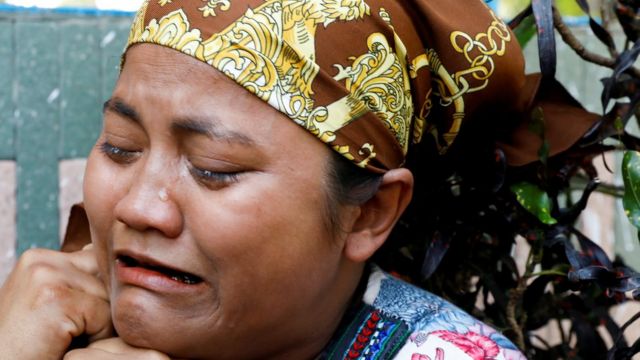 A relative of U Khin Maung Latt cries as she receives his dead body from a hospital in Yangon, 7 March
