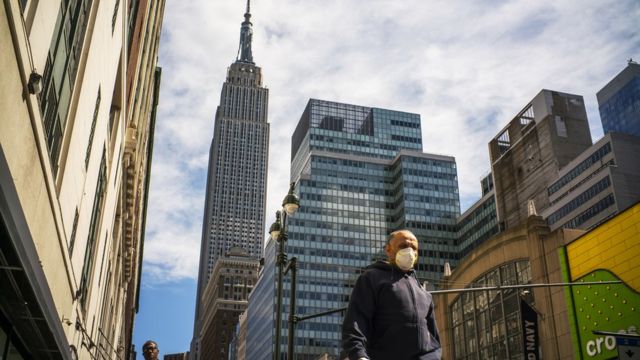 A man wears a face mask as the city streets are empty due to the coronavirus in New York City on 24 March 2020