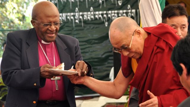 Spiritual leader Dalai Lama shares his birthday cake with retired Archbishop Desmond Tutu at the Tibetan Children's Village School in Dharmsala, India, 23 April 2015