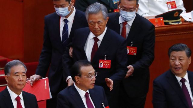China"s former President Hu Jintao (C, back) is led out as President Xi Jinping (R), Premier Li Keqiang (2-L) and Chairman of the National Committee of the Chinese People"s Political Consultative Conference Wang Yang (L) look on during the closing ceremony of the 20th National Congress of the Communist Party of China (CPC) at the Great Hall of People in Beijing, China, 22 October 2022.
