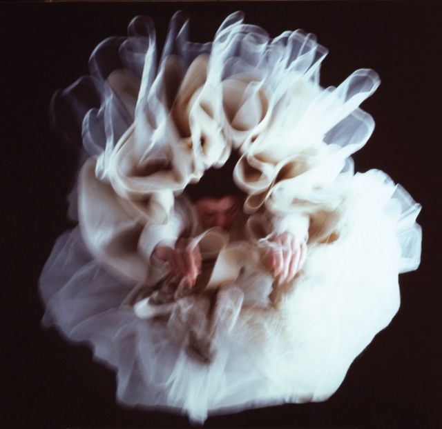 A blurred woman in a frilled dress