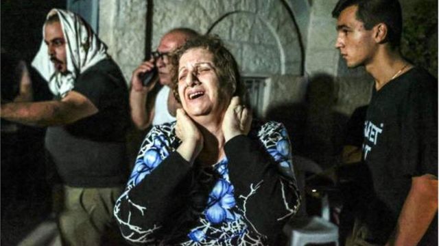 A woman cries at the Church of Saint Porphyrius in Gaza City