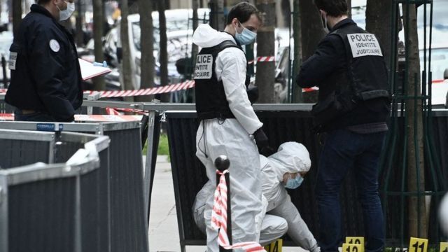 Police investigate the scene of a shooting outside a Paris hospital on 12 April 2021