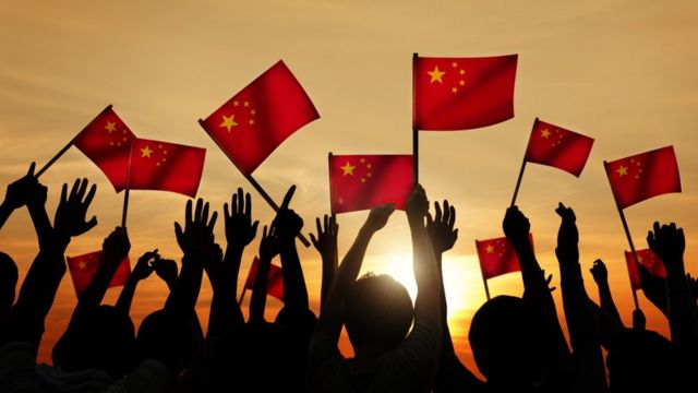 People waving China flag
