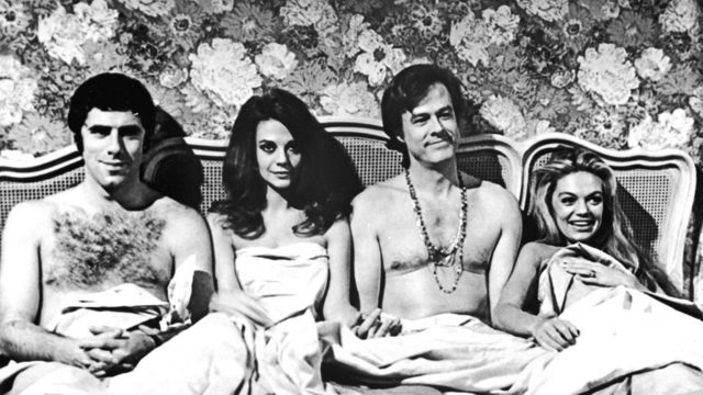 American actors Elliott Gould, Natalie Wood, Robert Culp and Dyan Cannon sit in bed together in a promotional still from the film, 'Bob & Carol & Ted & Alice,'