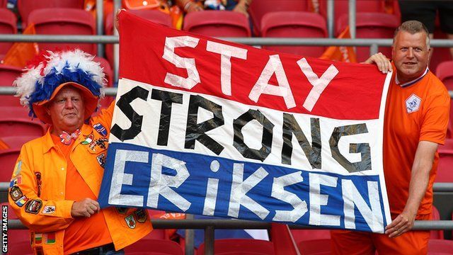 Fans displayed a flag urging Denmark's Christian Eriksen, who started his professional career at Ajax, to stay strong after he collapsed the previous day