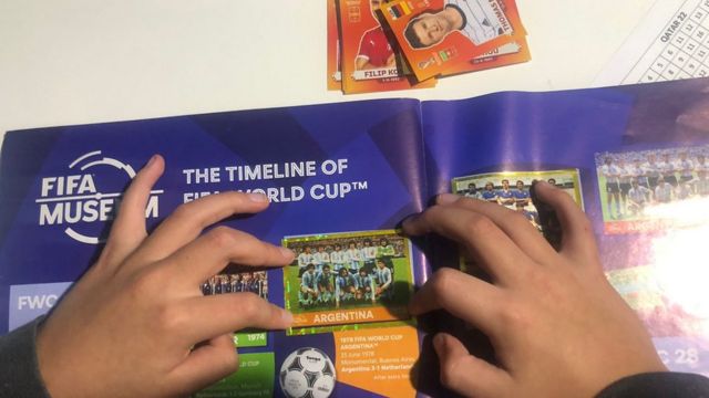 Hands of Rodrigo completing their World Cup figurine album.