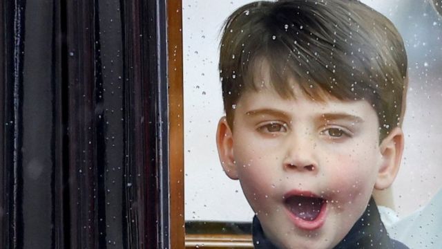 Prince Louis yawns as he travels in a coach