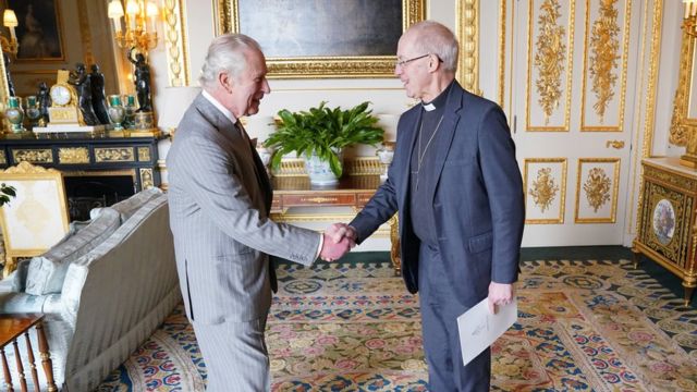 King Charles shakes hands with Archbishop of Canterbury Justin Welby.