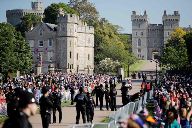Well-wishers gather along the Long Walk leading to Windsor Castle ahead of the wedding and carriage procession of Britain's Prince Harry and Meghan Markle in Windsor