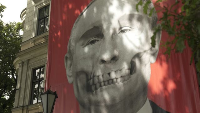 A mural depicting a skull with the features of Russian President Vladimir Putin is displayed opposite the Russian Embassy in Latvia's capital, Riga.