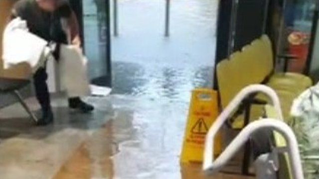 A person tries to mop up the flooding at Rotherham General Hospital
