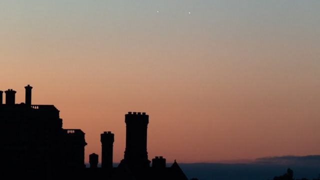 Photo supplied by Alan Crossland on Twitter of two small planets in the sky above Hampton Court Palace at sunrise