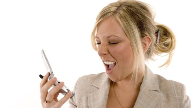 Una modelo con el cabello recogido con una pinza de garra mientras habla por celular.