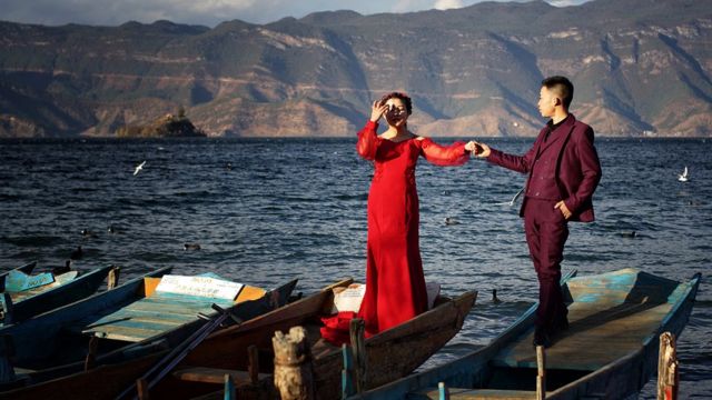 Joven matrimonio chino a orillas del lago Lugu.