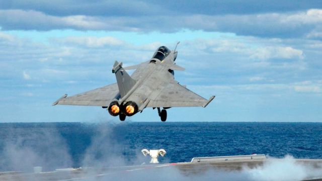 French fighter jet taking off from aircraft carrier.