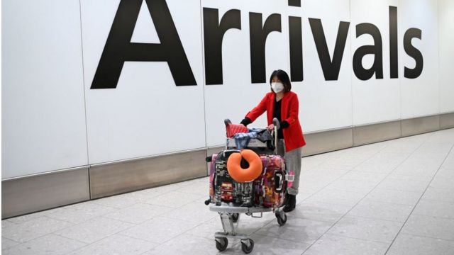 A woman arrives at Heathrow