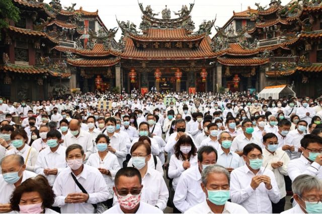 People holding joss sticks pray to the sea goddess Mazu for rain amid an island-wide drought, during a religious ceremony at Jenn Lann Temple in Taichung, Taiwan on March 7, 2021.