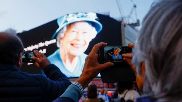 An image of the Her Late Majesty Queen Elizabeth II displayed at Piccadilly Circus