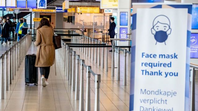 A woman with a suitcase at an Schiphol International Airport on January 22, 2021 in Amsterdam, Netherland