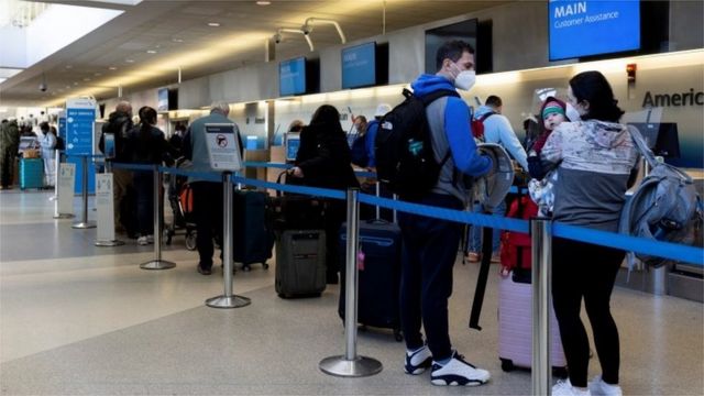 Travellers wait in line at the Philadelphia International Airport