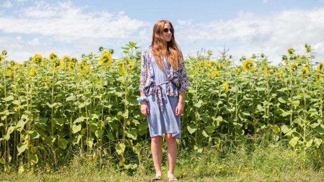 Kate Hall in a field of sunflowers