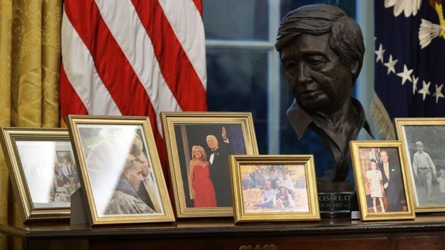 A bust of Cesar Chavez clipped next to photos of the Biden family