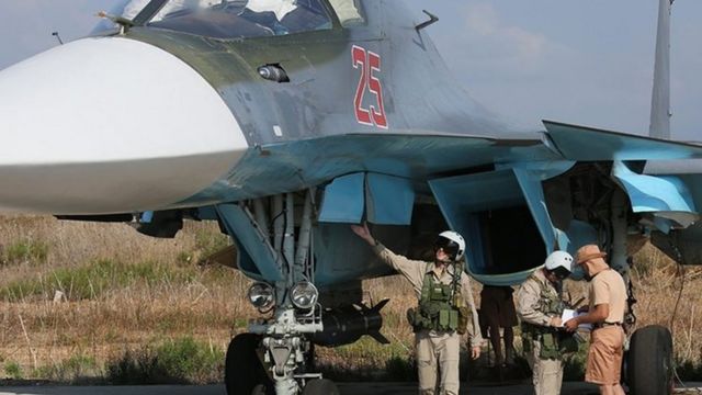 Russian military personnel check a Russian combat aircraft at Hmeymim air base, Syria. Photo: 3 October 2015