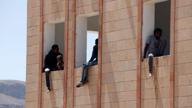 Ethiopian migrants inside a building while under quarantine as they cross Yemen to reach Saudi Arabia