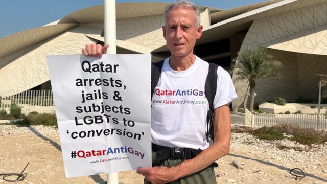 Peter Tatchell holds a poster with the hashtag 'Qatar Anti Gay'