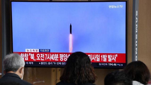 People watch a TV screen showing news with archival footage of North Korea's missile test, at a train station in Seoul on November 3, 2022.