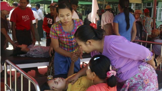 Women comfort a victim receiving treatment at temporary shelter outside the hospital after an earthquake in Taikkyi township northeast of Yangon, Myanmar, Tuesday, March 14, 2017. The U.S.
