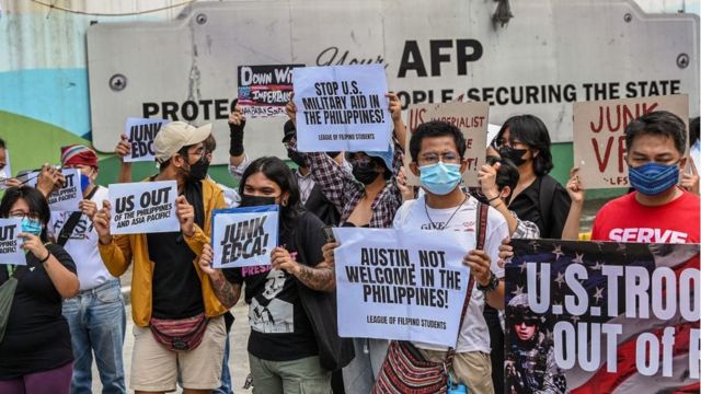 A group of people demonstrate against the return of US soldiers to the Philippines in February 2023.