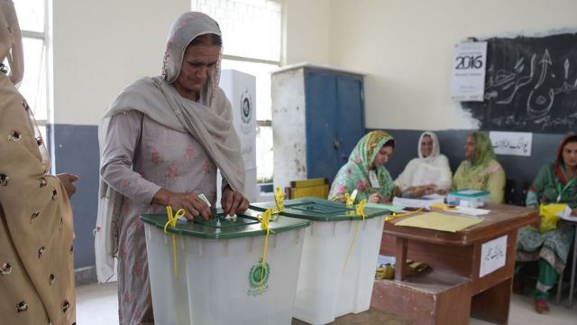 A woman casts her vote during Pakistan"s general election