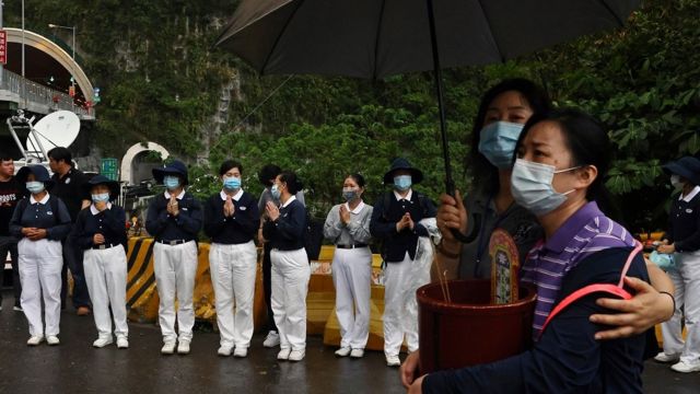 Relatives of the victims grieve near the site a day after the deadly train derailment at a tunnel north of Hualien, Taiwan April 3, 2021.