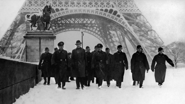 German Soldiers Cross The Iena Bridge, Covered In Snow, In Front Of The Eiffel Tower In Paris in January 1941