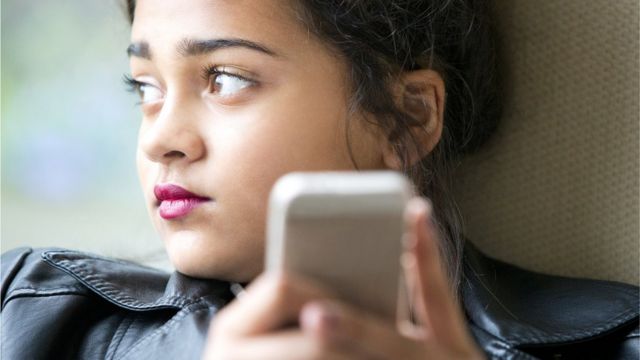 File picture of young person using mobile phone