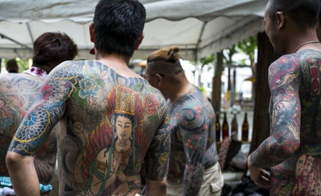 Yakuza members display their tattoos at the Sanja Matsuri Festival in Tokyo's Asakusa district, on May 14, 2016.