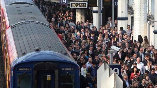 File photo dated 30/04/14 of commuters using overground train services waiting to pass through the barriers at Waterloo station, London, during strike by tube workers