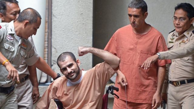 Saeid Moradi, 29, (C), an Iranian suspected of being involved in the February 2012 bomb explosions in Bangkok, gestures to the media alongside Mohammad Khazaei (2nd R), 43, during a hearing in the Bangkok South Criminal Court in August.  22 of 2013.