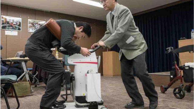 A photo of a hug with a robot caregiver, known as a mobile assistance robot, displayed in Tokyo, Japan, February 2018.