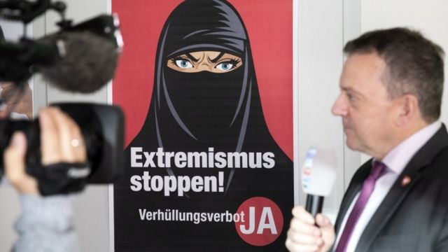 A poster depicting a woman wearing the niqab in Switzerland