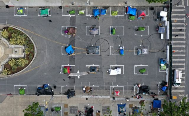 An aerial view showing tents set up in individually marked spaces on the ground