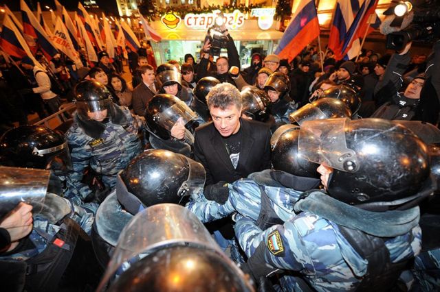 Riot police encircle Russian opposition leader Boris Nemtsov (C), detained while taking part in an unauthorized rally, on Triumfalnaya Square in central Moscow, late on December 6, 2011. (Photo by KIRILL KUDRYAVTSEV/AFP via Getty Images)