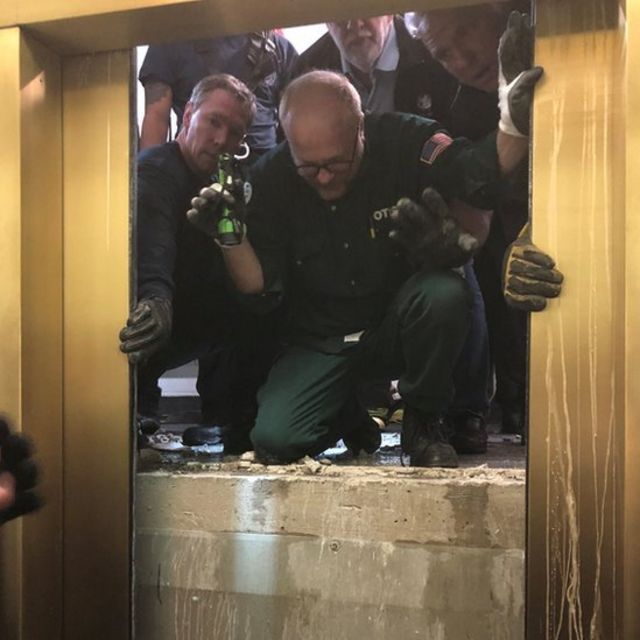 Rescuers open the lift door to reach those trapped, on 16 November 2018