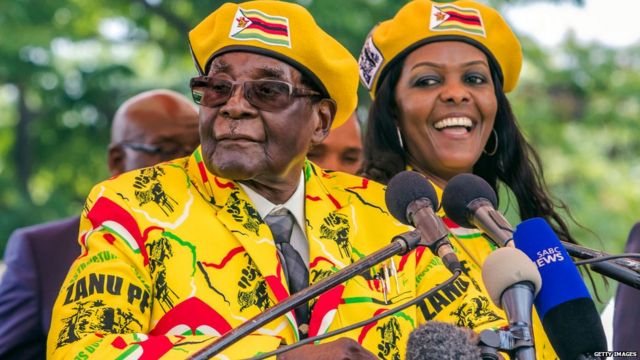 Robert Mugabe (L) addresses party members and supporters gathered at his party headquarters to show support to Grace Mugabe (R) becoming the party's next Vice President after the dismissal of Emerson Mnangagwa November 8 2017.